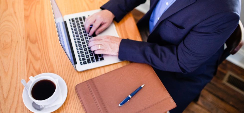 How we can help - Jim White working at a laptop