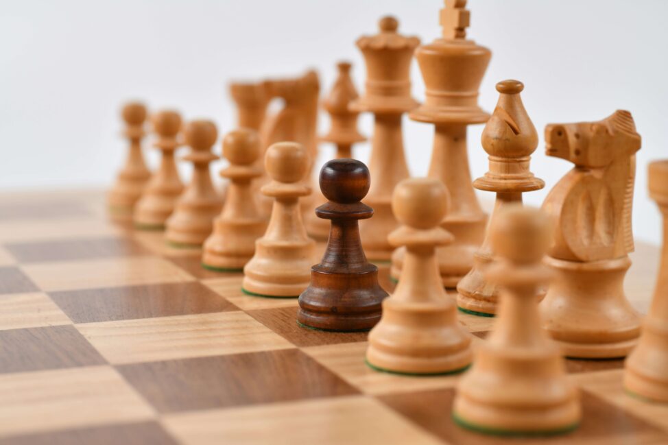 Wooden chess pieces on board representing strategic high net worth tax planning and wealth preservation techniques