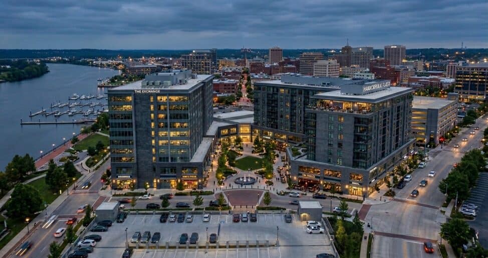 Real estate tax strategies for high earners, aerial view of commercial mixed-use development at dusk